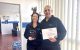 Einat and Shlomi Kuba holding the 2026 Logan Business Distinction Awards trophy and Certificate of Distinction for the Automotive and Transport Small category at K&G Automotive in Underwood