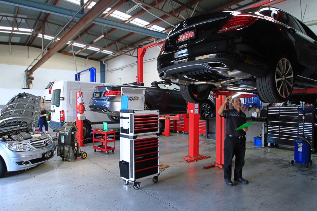 Shlomi Kuba inspecting a Mercedes-Benz C-Class on the hoist at K&G Automotive in Underwood